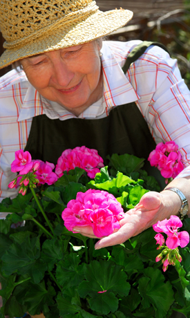 old woman with flowers 1 - www.HowCanIRetire.net